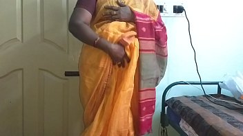 Vanitha’s Sultry Orange Saree Slips Aside As She Teases Her Bare Pussy And Squeezes Her Heavy Tits, Moaning Softly As She Fingers Herself.
